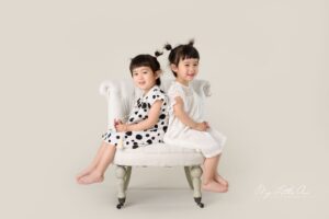 two girls sitting on chair