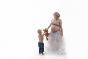 my little one photography pregnant lady grey tulle and toddler holding bear